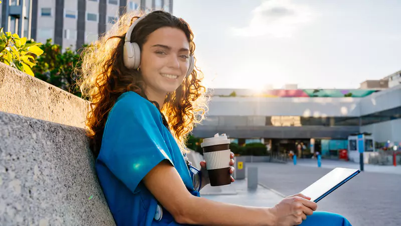 Young informatics nurse smiling outdoors, symbolizing the rewarding career and bright future in nursing informatics