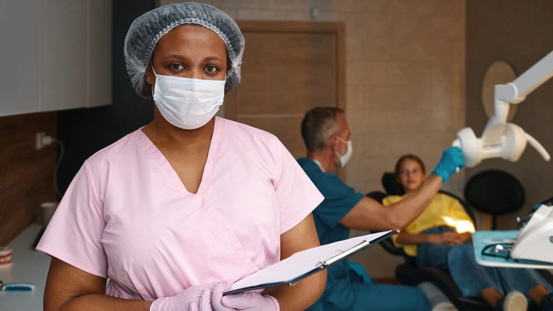 Confident nurse holding clipboard in clinical setting, highlighting highest paying nursing jobs