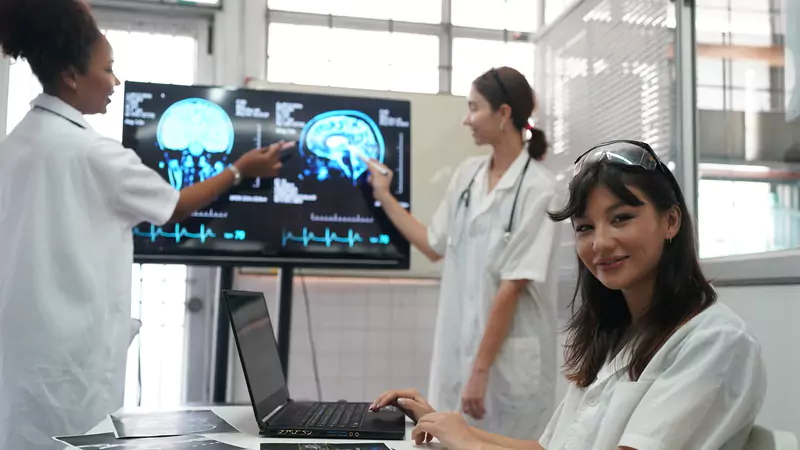 Nursing informatics team reviewing medical imaging and data analytics for healthcare advancement opportunities