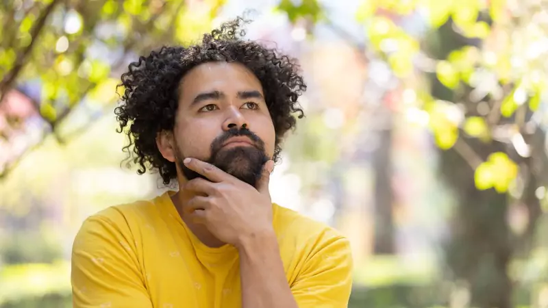 Man thoughtfully considering his options for choosing the right travel nurse agency and assignment
