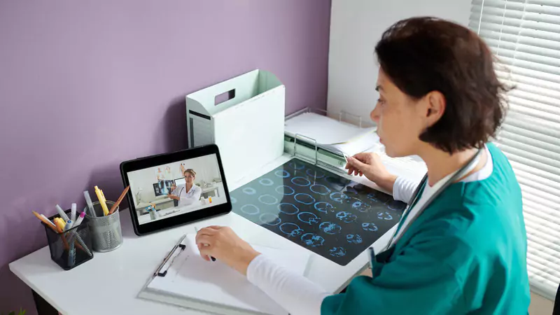 Remote nurse reviewing medical scans and conducting virtual consultation, highlighting exciting opportunities in online nursing
