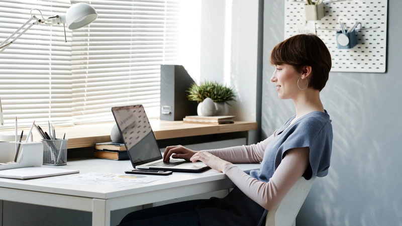 Young professional woman working comfortably from home office