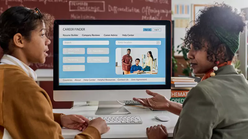 Two professionals reviewing online nursing job opportunities on a career-finding website, highlighting remote nursing careers