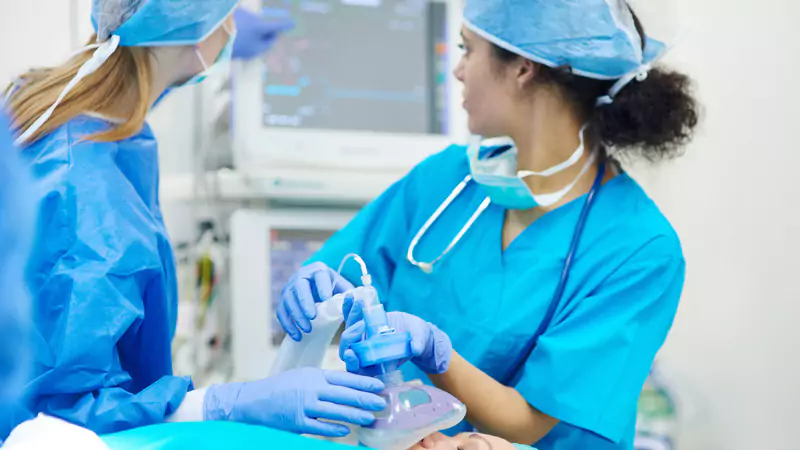 Nurse anesthetist carefully administering anesthesia and monitoring patient vitals, illustrating career growth and professional skills