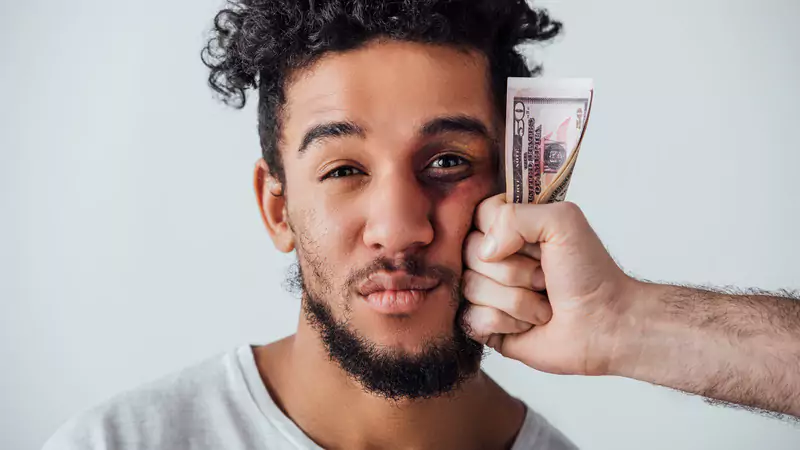 man-with-bruise-being-punched-by-hand-holding-money