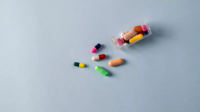 scattered-colorful-pills-on-blue-surface-representing-medical-supplies-that-need-better-tracking
