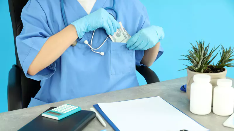 nurse-putting-dollar-bills-in-scrub-pocket-salary-income-concept