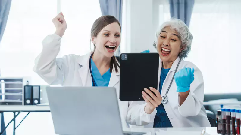 happy-nurses-celebrating-paid-survey-success-on-digital-tablet