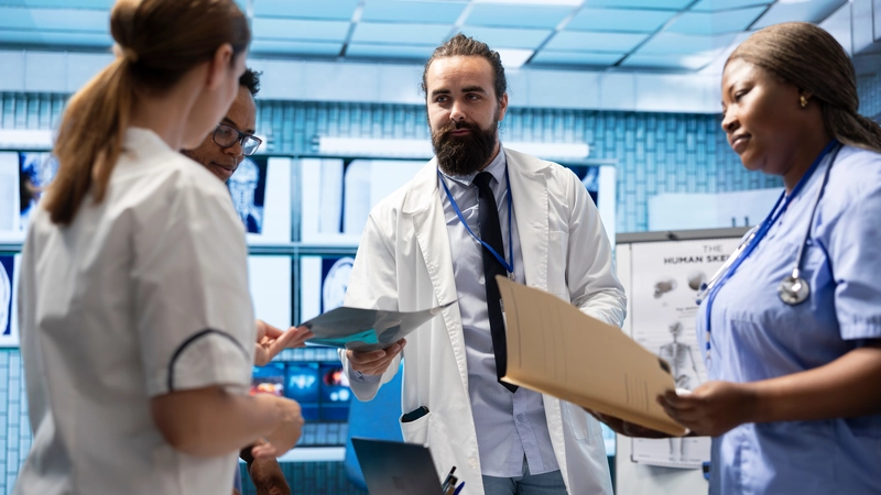 Healthcare professionals in a strategic meeting discussing medical reports and leadership decisions, highlighting common causes of hospital politics