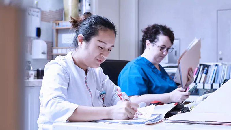 nurses-completing-paperwork-in-hospital-setting-during-shift