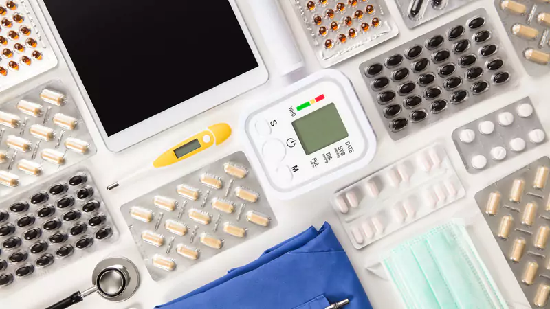 medical-supplies-including-pills-scrubs-tablet-and-blood-pressure-monitor-organized-on-table