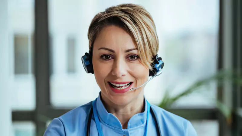 nurse-navigator-on-headset-smiling-during-telehealth-call
