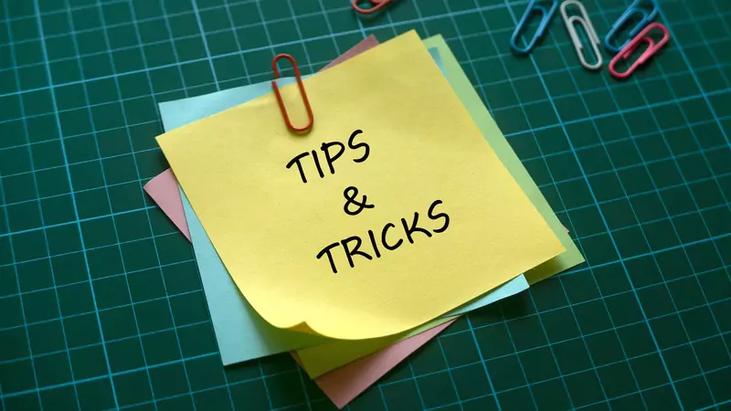 sticky-note-labeled-tips-and-tricks-on-green-grid-desk