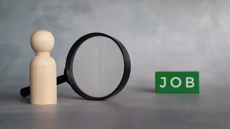 wooden-person-with-magnifying-glass-looking-for-job-opportunity